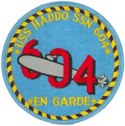 SSN-604 USS Haddo 
Namesake. The haddo, a pink salmon fish prevalent on the Pacific coast of the United States and Canada.
Ordered. 3 Mar 1959
Builder. New York Shipbuilding Corporation
Laid down. 9 Sep 1960
Launched. 18 Aug 1962
Commissioned. 16 Dec 1964
Decommissioned. 12 Jun 1991
Stricken	. 12 Jun 1991
Fate. Disposed of by submarine recycling
Motto. Latin 'En Guard' (On [your] guard)
Class and type. Permit-class submarine
Displacement:	
3,700 tons surfaced,
4300 tons submerged
Length. 278 ft 6 in (84.89 m)
Beam. 31 ft 8 in (9.65 m)
Propulsion. S5W reactor
Speed. 20 knots
Complement. 100 officers and men
Armament. 4 × 21 in (533 mm) torpedo tubes

