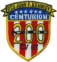 CV-67 USS John F Kennedy 200 Carrier Landings
Namesake. John F Kennedy, (1917-1963), 35th president of the USA
Awarded. 30 Apr 1964
Builder. Newport News Shipbuilding, VA
Laid down. 22 Oct 1964
Launched. 27 May 1967
Christened. 27 May 1967
Commissioned. 7 Sep 1968
Decommissioned. 23 Mar 2007
Stricken. 16 Oct 2009
Fate. Sold to International Shipbreaking Limited on 6 Oct 2021 to be dismantled 
Motto Date Nolite Rogare (Give, do not ask)
Type. variant of the Kitty Hawk class aircraft carrier
Displacement:	
60,728 tons light
82,655 tons full load
21,927 tons deadweight
Length. 1,052 ft (321 m) overall, 990 ft (300 m) waterline
Beam. 252 ft (77 m) extreme, 130 ft (40 m) waterline
Height. 192 ft (59 m) from top of the mast to the waterline
Draft. 36 ft (11 m) maximum, 37 ft (11 m) limit
Installed power. 8 × Babcock & Wilcox boilers, 1,200 PSI 280,000 shp (210 MW)
Propulsion:	
4 × steam turbines
4 shafts
Speed	34 knots (63 km/h; 39 mph)
Capacity. 5,000+
Complement. 3,297 officers and men (without jet commands & crews)
Armament:	
2 × GMLS Mk 29 launchers for Sea Sparrow missiles
2 × Phalanx CIWS
2 × RAM launchers
Aircraft carried. 	80+

