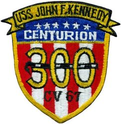 CV-67 USS John F Kennedy 300 Carrier Landings
Namesake. John F Kennedy, (1917-1963), 35th president of the USA
Awarded. 30 Apr 1964
Builder. Newport News Shipbuilding, VA
Laid down. 22 Oct 1964
Launched. 27 May 1967
Christened. 27 May 1967
Commissioned. 7 Sep 1968
Decommissioned. 23 Mar 2007
Stricken. 16 Oct 2009
Fate. Sold to International Shipbreaking Limited on 6 Oct 2021 to be dismantled 
Motto Date Nolite Rogare (Give, do not ask)
Type. variant of the Kitty Hawk class aircraft carrier
Displacement:	
60,728 tons light
82,655 tons full load
21,927 tons deadweight
Length. 1,052 ft (321 m) overall, 990 ft (300 m) waterline
Beam. 252 ft (77 m) extreme, 130 ft (40 m) waterline
Height. 192 ft (59 m) from top of the mast to the waterline
Draft. 36 ft (11 m) maximum, 37 ft (11 m) limit
Installed power. 8 × Babcock & Wilcox boilers, 1,200 PSI 280,000 shp (210 MW)
Propulsion:	
4 × steam turbines
4 shafts
Speed	34 knots (63 km/h; 39 mph)
Capacity. 5,000+
Complement. 3,297 officers and men (without jet commands & crews)
Armament:	
2 × GMLS Mk 29 launchers for Sea Sparrow missiles
2 × Phalanx CIWS
2 × RAM launchers
Aircraft carried. 	80+

